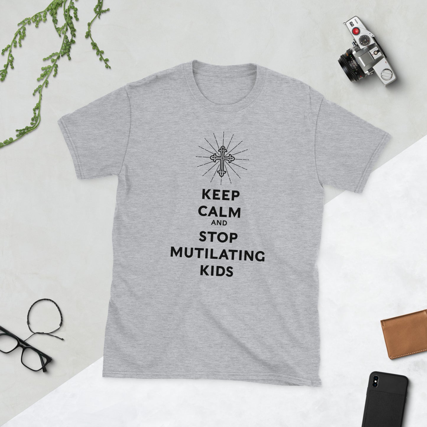 Whit shirt with the slogan "keep calm and stop mutilating kids" with a vector Christian cross on top